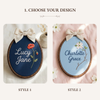 Two styles of embroidered oval hoop name signs with linen bows: Lucy Jane and Charlotte Grace.